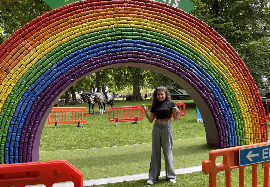 Jules in London under recycled can rainbow