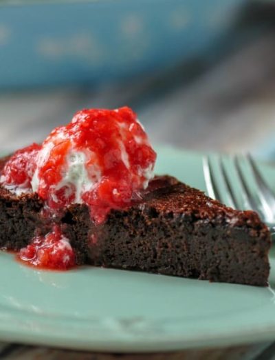 gluten free hot fudge pie with homemade coconut whipped cream and berry coulis slice