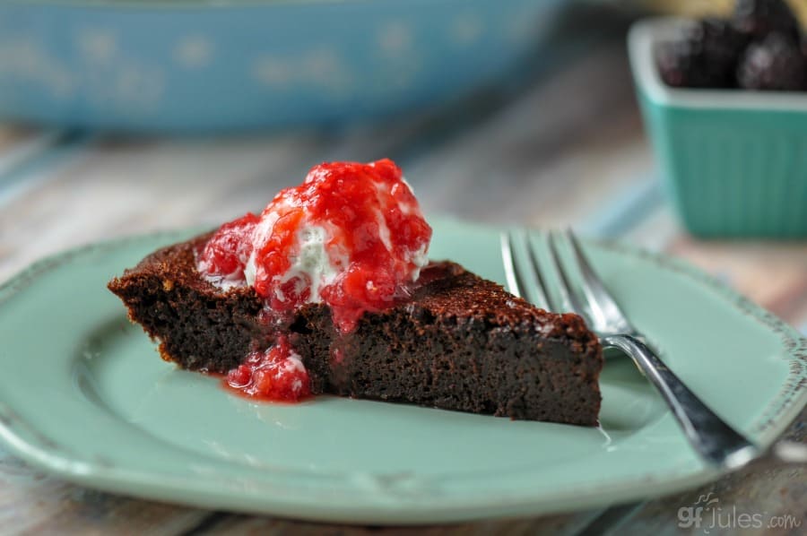 gluten free hot fudge pie with homemade coconut whipped cream and berry coulis slice