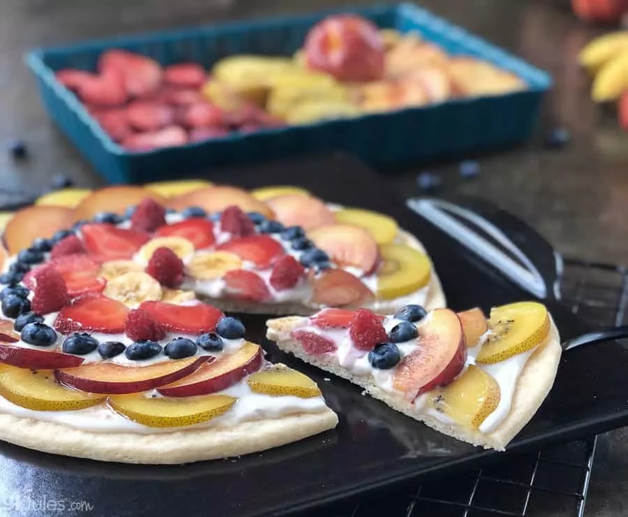 gluten free fruit pizza on emile henry tray with slice 2