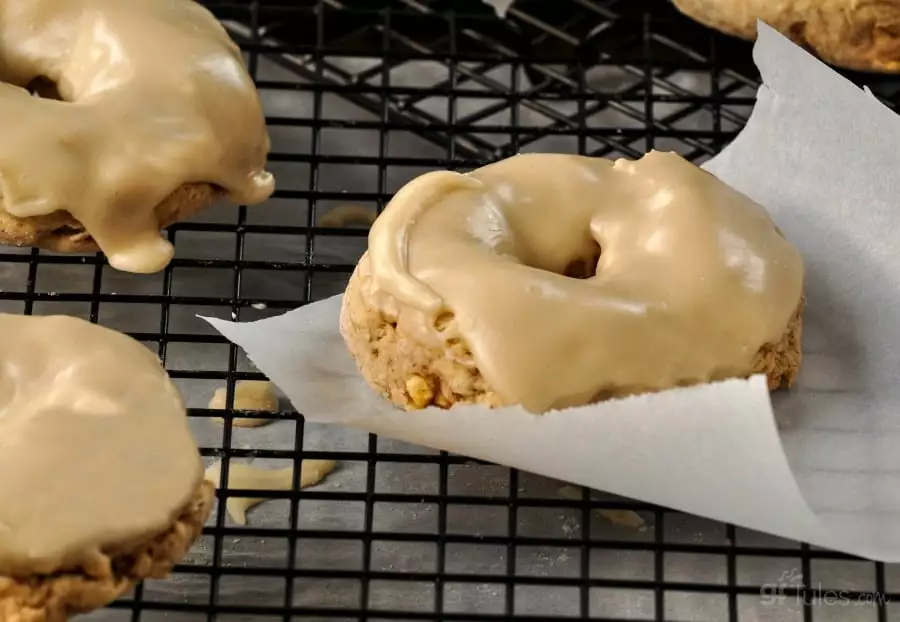 gluten free apple cider donuts on rack with paper