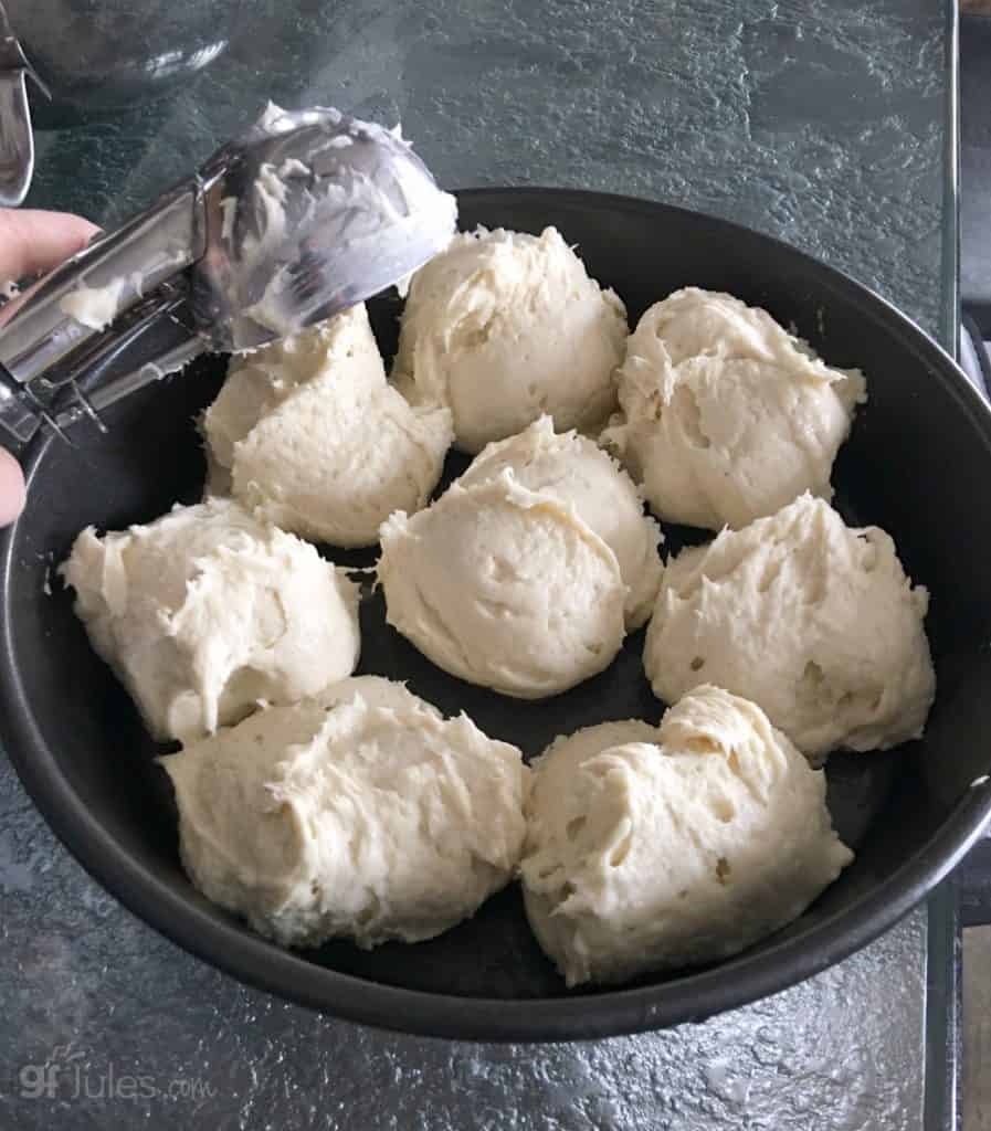 scooping gluten free pull apart dinner rolls