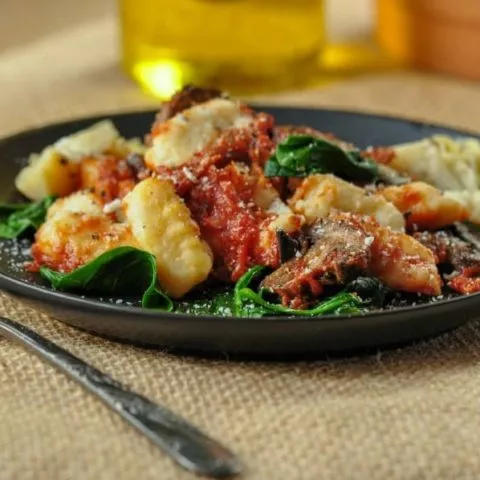 gluten free potato gnocchi on plate with mushrooms