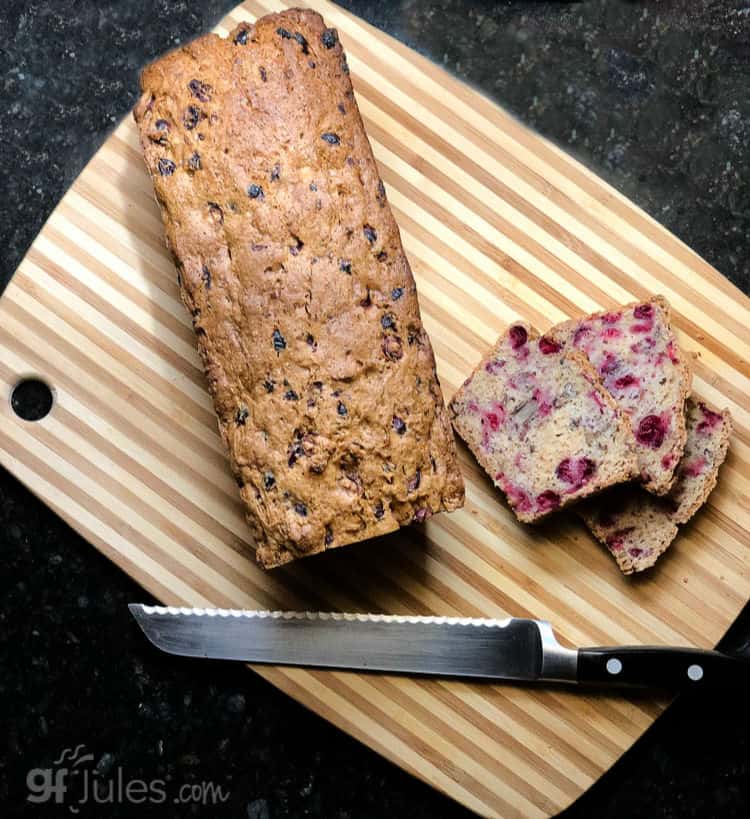 gluten free cranberry orange quick bread on board with knife