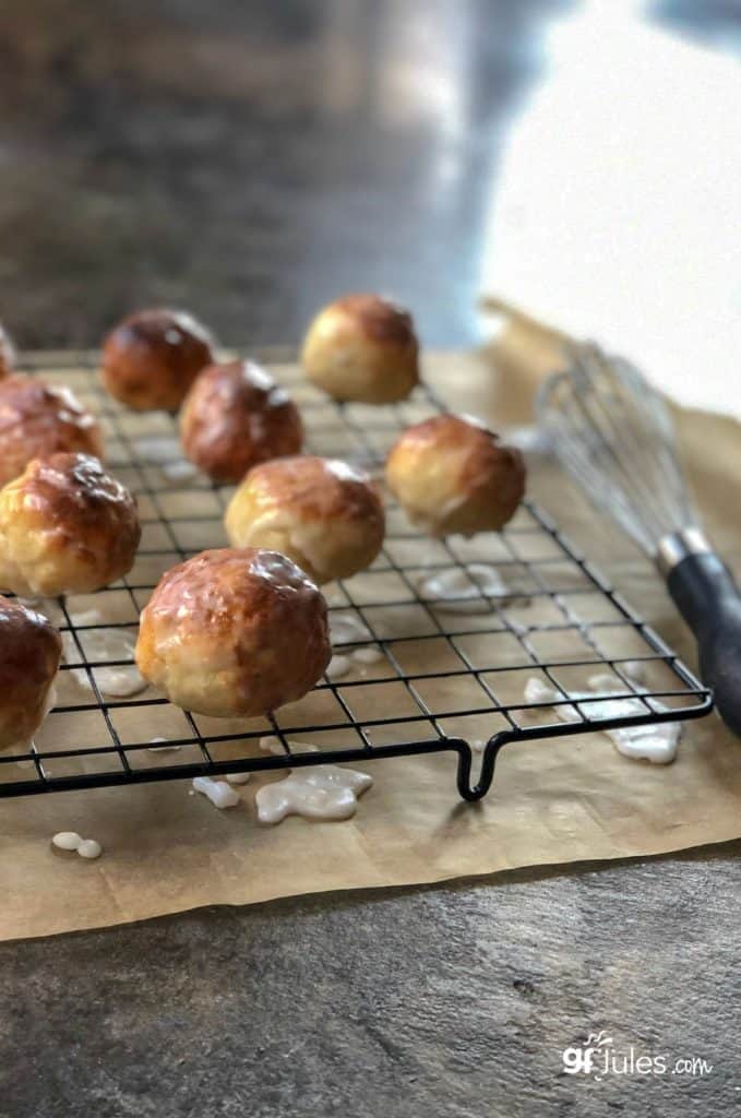 gluten free doughnut holes on rack with glaze