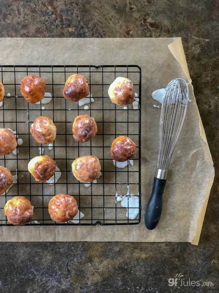 gluten free doughnut holes on rack with whisk