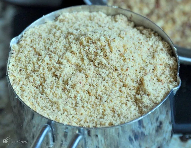 almonds ground into homemade almond flour in measuring cup