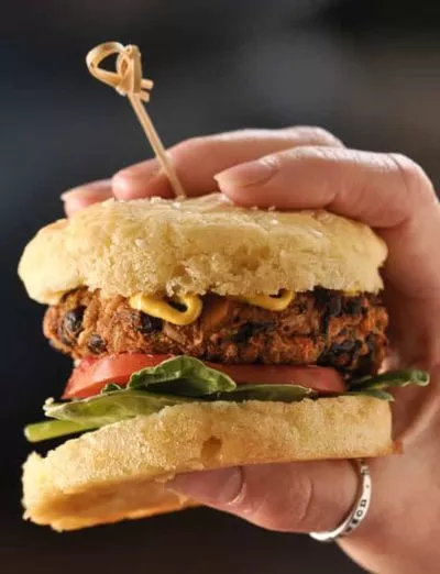 gluten free sweet potato black bean veggie burger on bun in hand