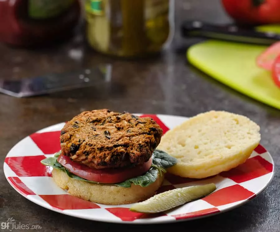 gluten free sweet potato black bean veggie burger on bun with pickle