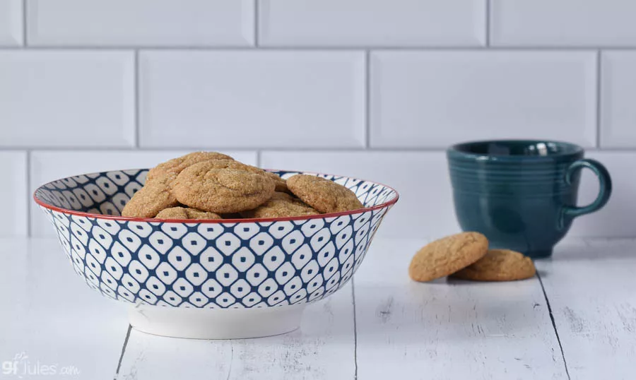soft gluten free molasses cookies in bowl wide | gfJules