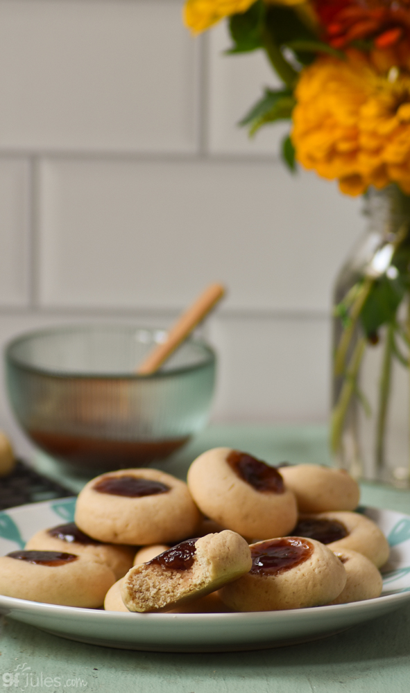 gluten free thumbprint cookies on plate with bite | gfJules