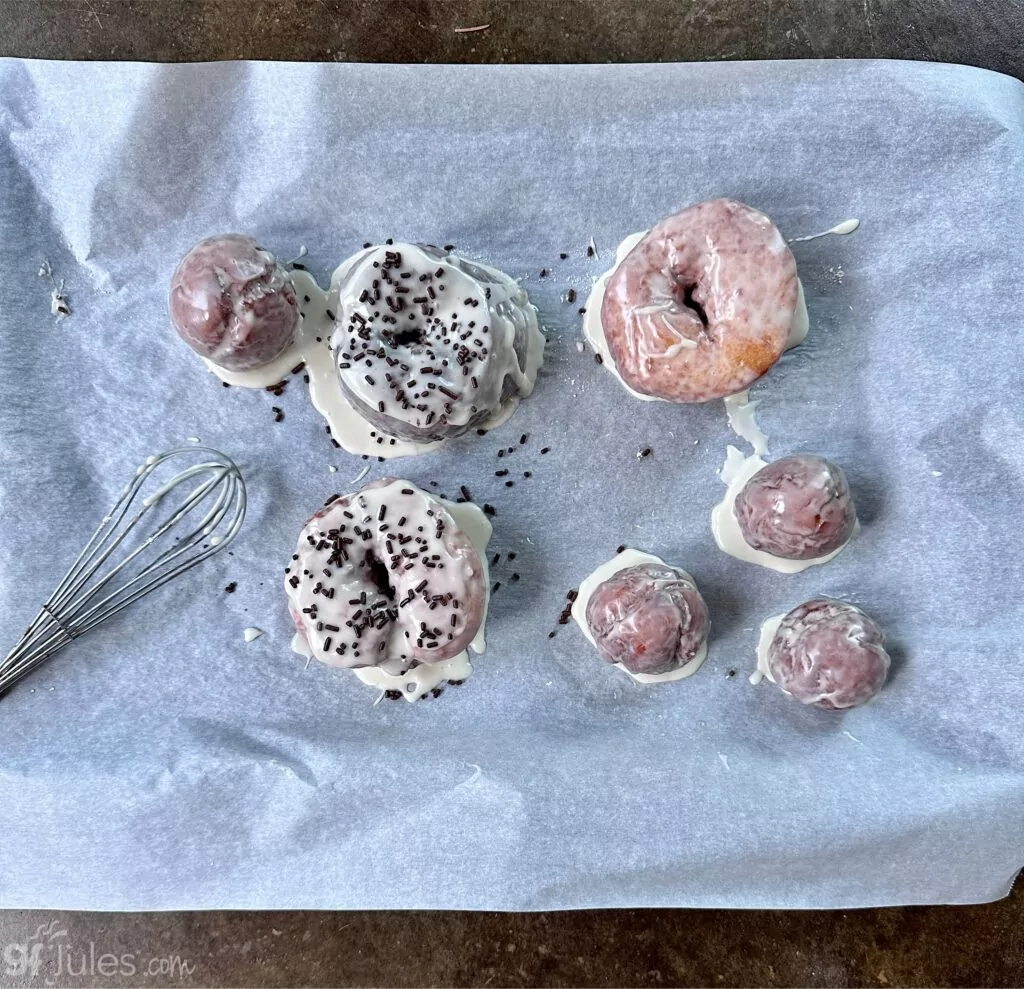 gluten free fried doughnuts on tray with glaze