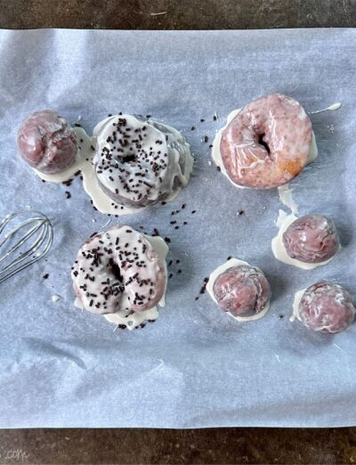 gluten free fried doughnuts on tray with glaze