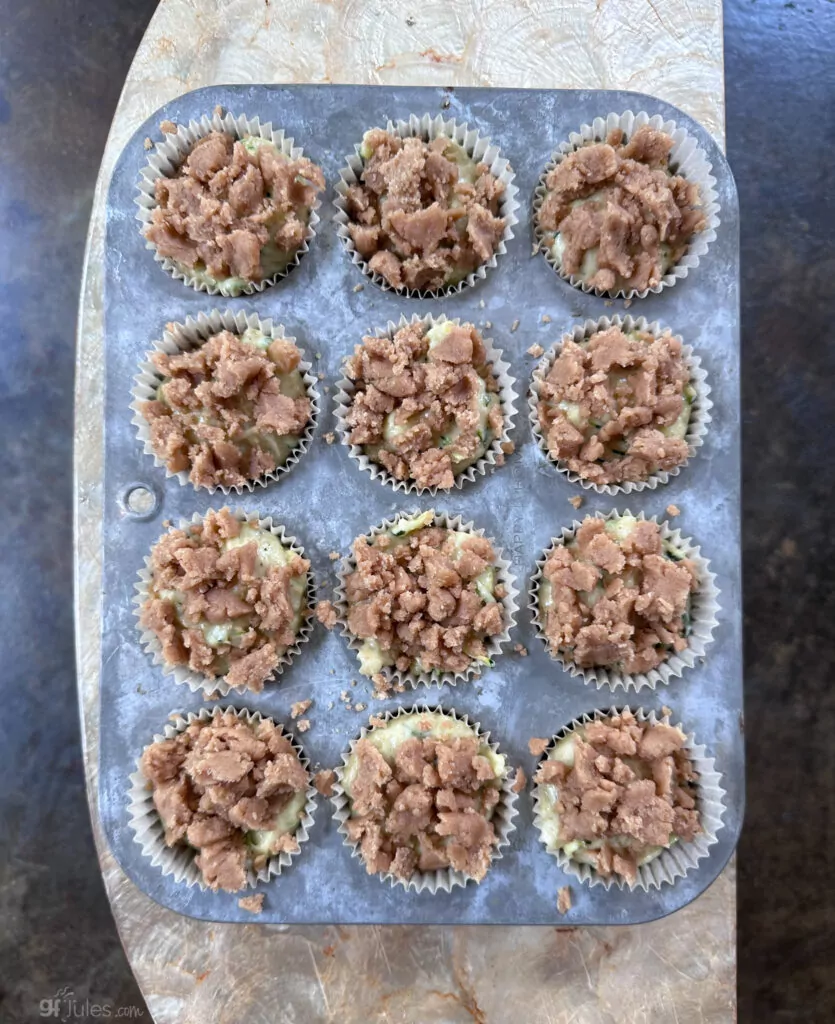 Gluten Free Zucchini muffins with muffin mix and crumble topping before bake