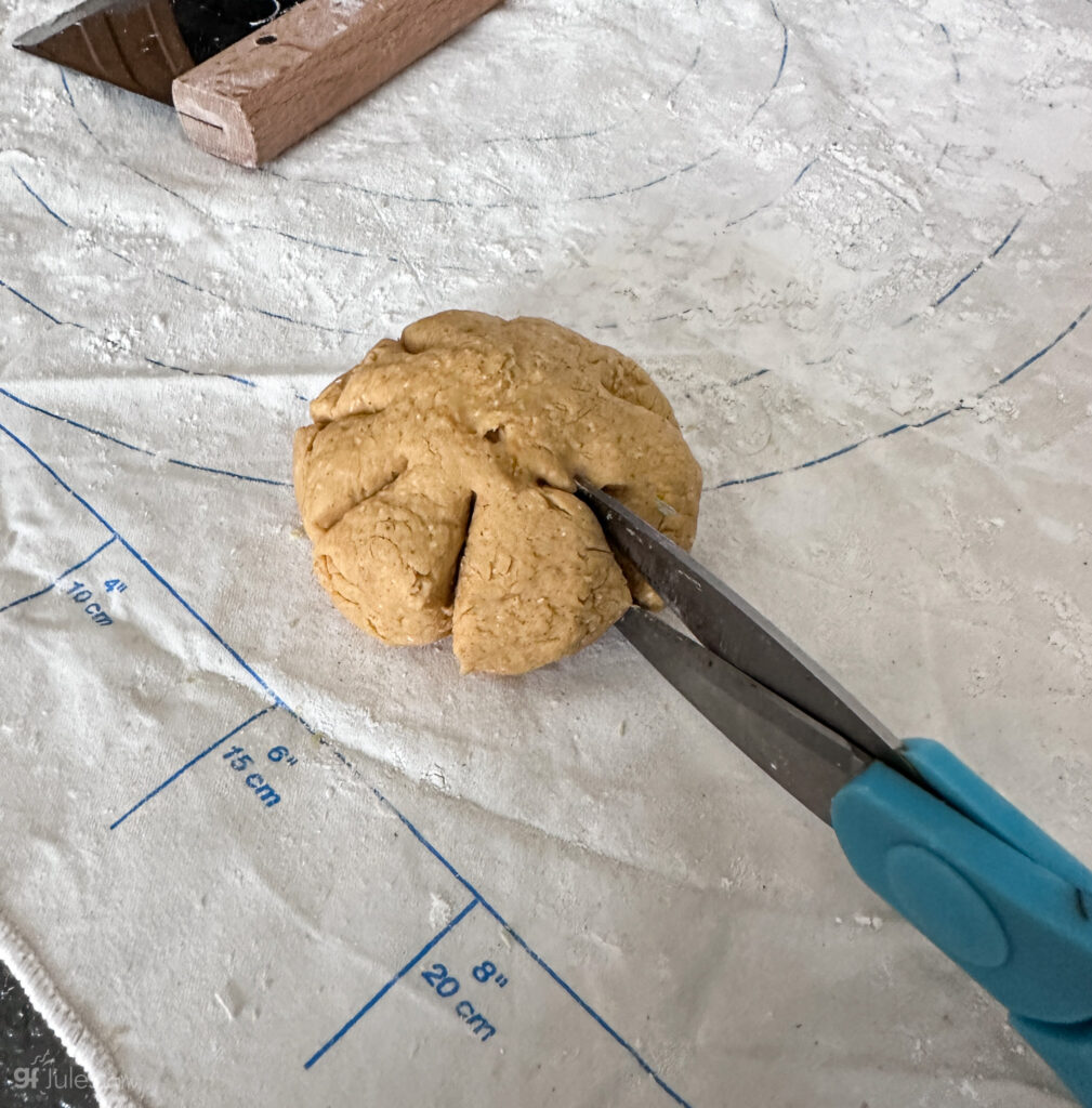 Making gluten free Pumpkin Shaped Rolls by snipping with scissors