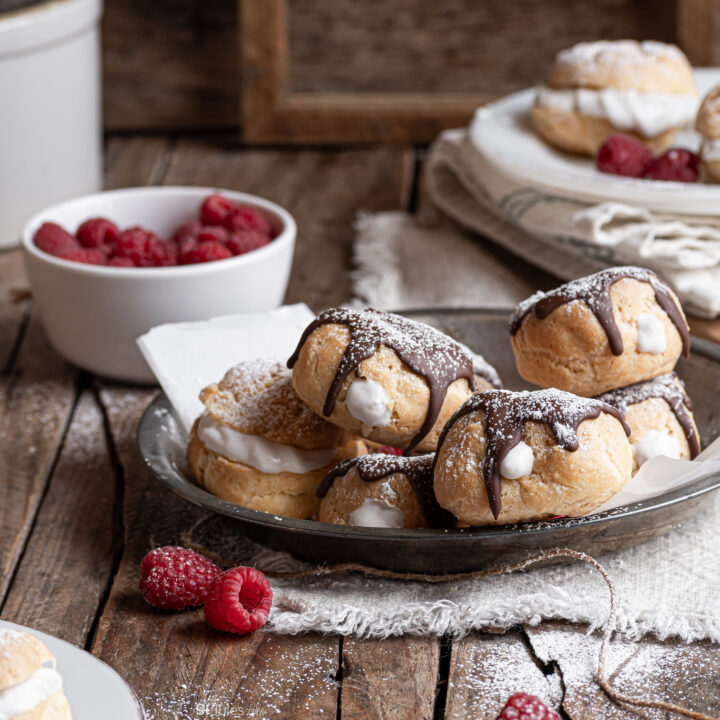 gluten free cream puffs on plate with berries sq