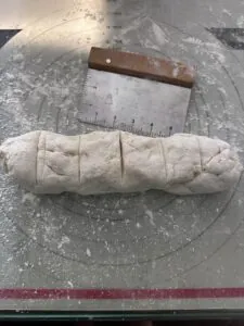 gluten free bagel dough with bench scraper