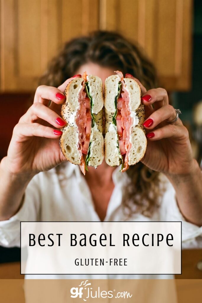 jules holding homemade gluten free bagel sandwich cut in half