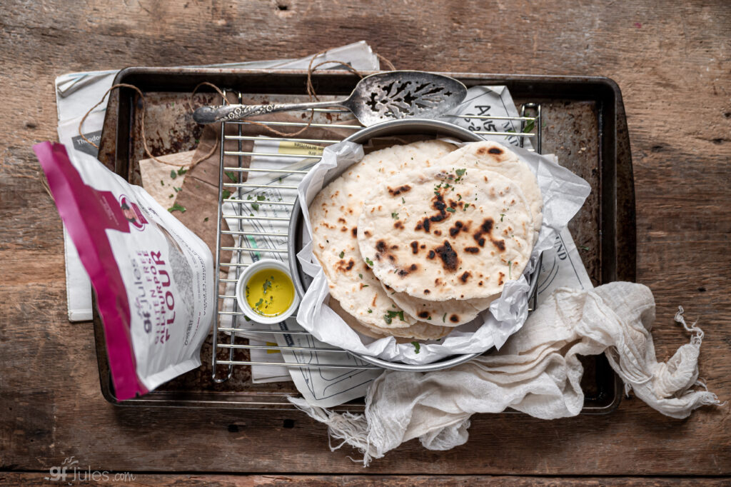 gluten-free naan breads stacked on wire rack made with gfJules Gluten Free All-Purpose Flour