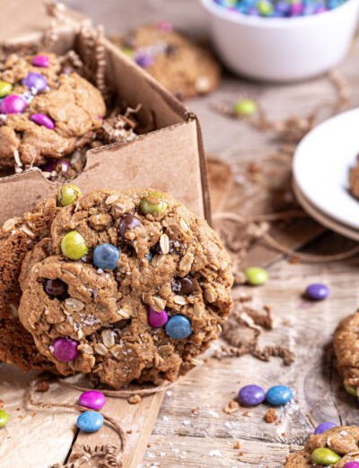 Close-up side view of gluten free monster cookie showing oats, peanut butter, and chocolate chips.
