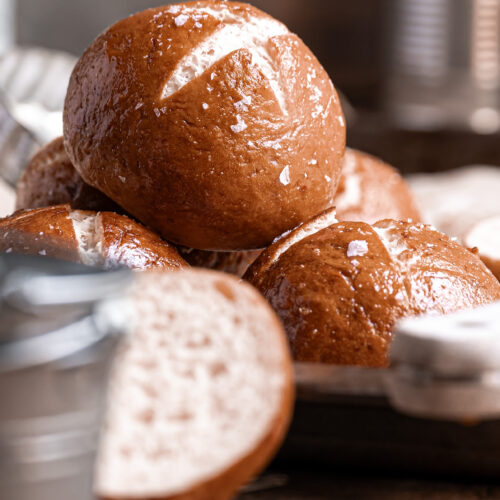 Golden-brown gluten free pretzel rolls stacked, made with gfJules Gluten Free All Purpose Flour