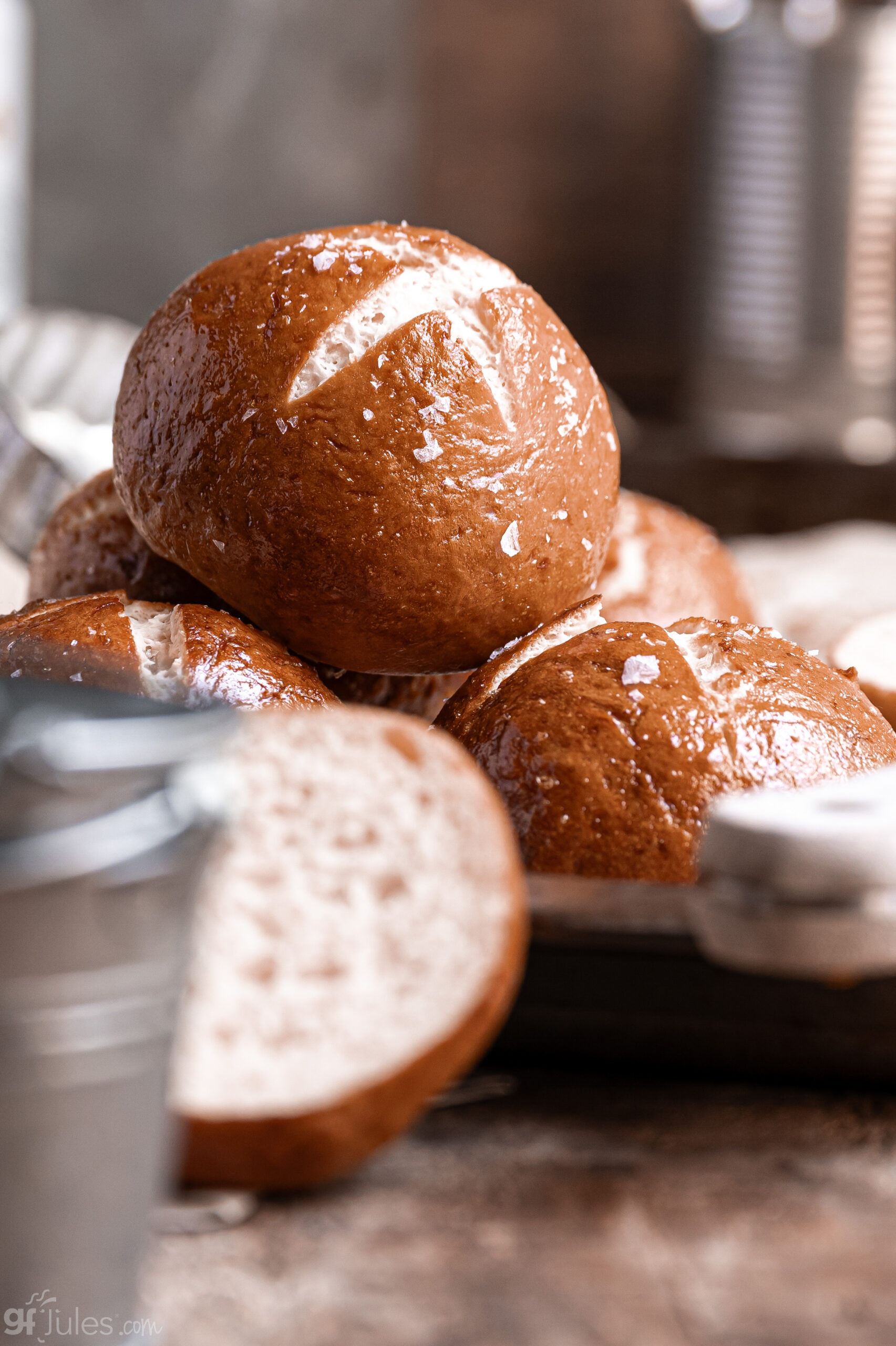 Golden-brown gluten free pretzel rolls stacked, made with gfJules Gluten Free All Purpose Flour
