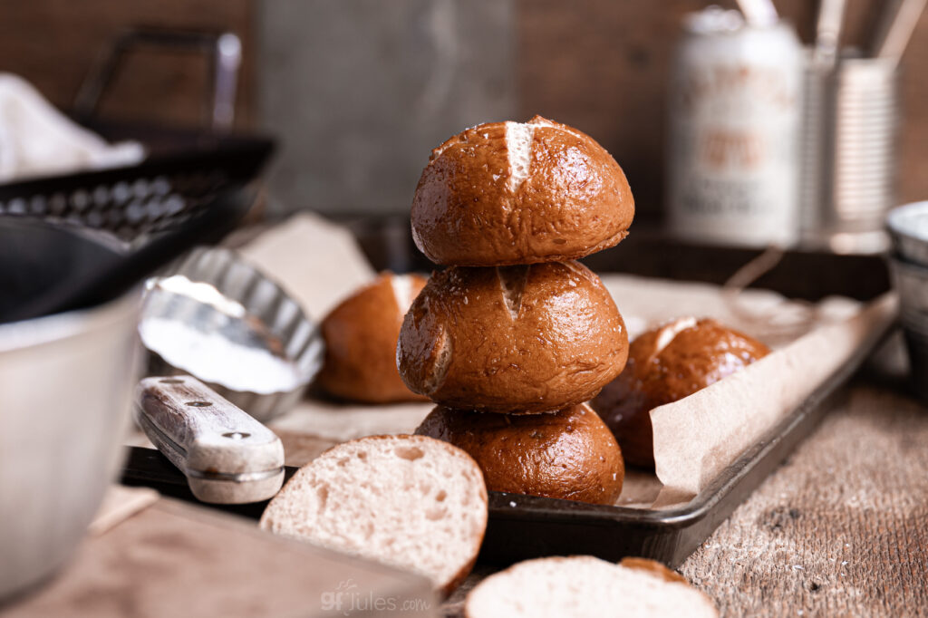 Golden-brown gluten free pretzel rolls stacked