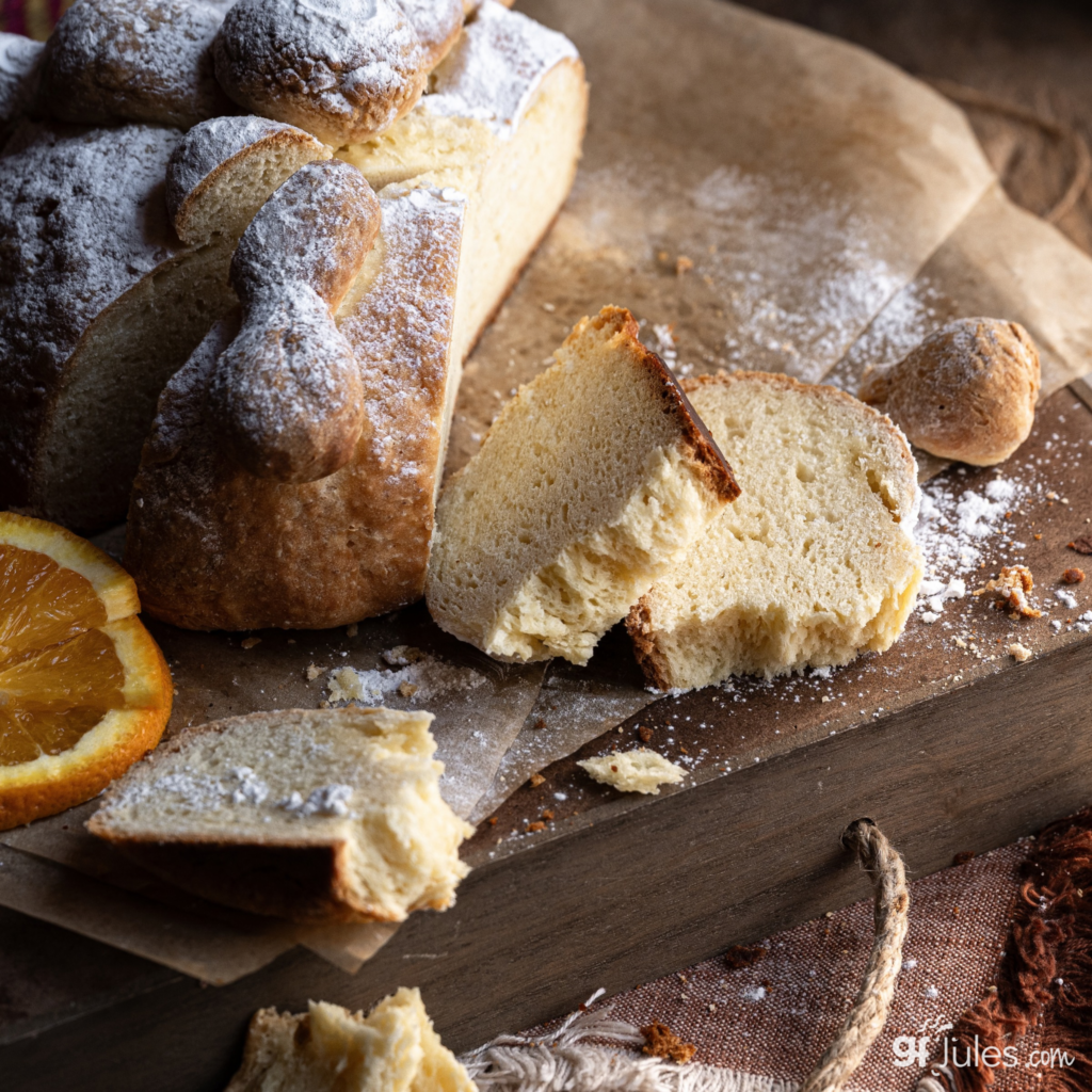 gluten free pan de muerto sliced on board